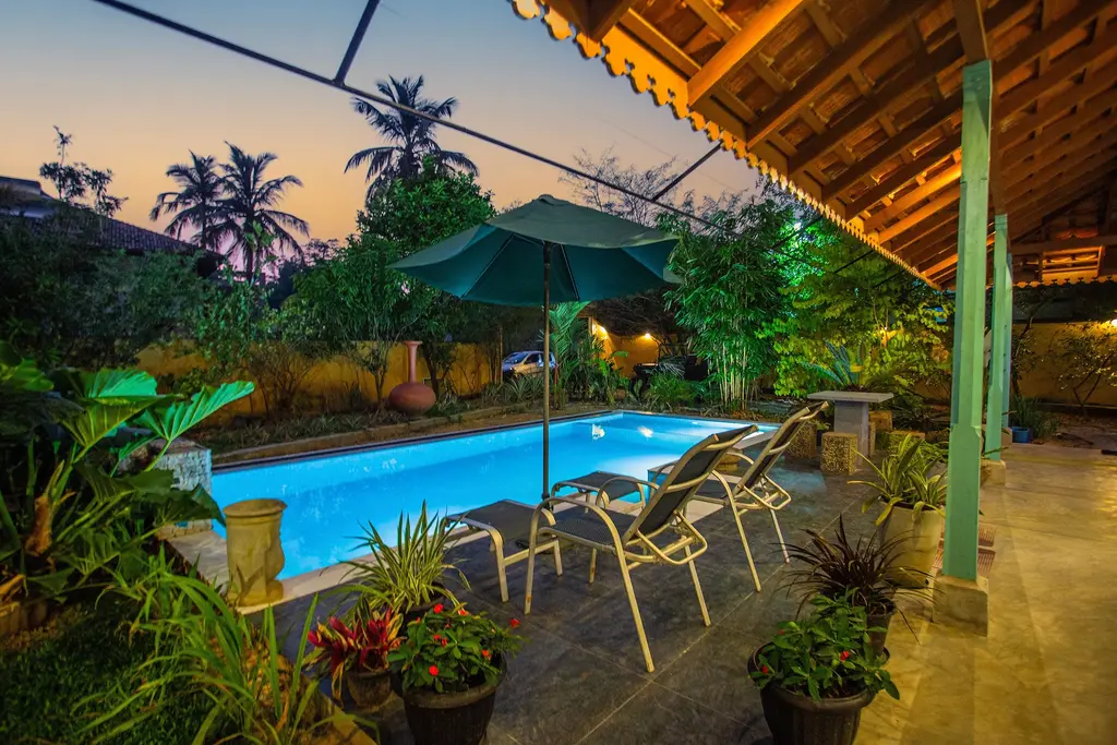 View from the covered veranda across the pool at sunset