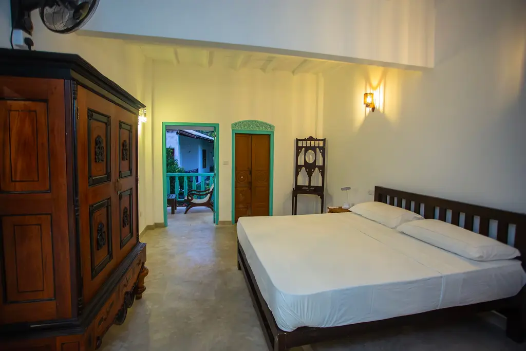 Large bedroom with an antique wardrobe and a door to the veranda